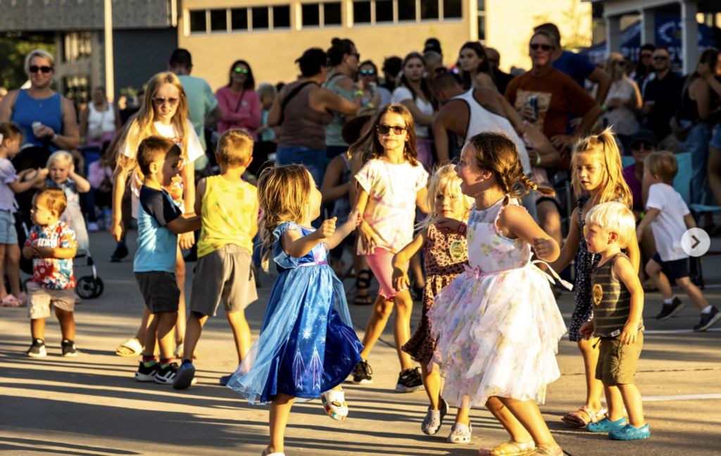 Children dancing in the street during the North Liberty Street Dance